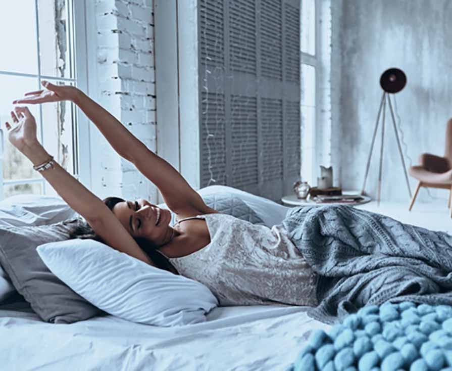white women stretching in bed