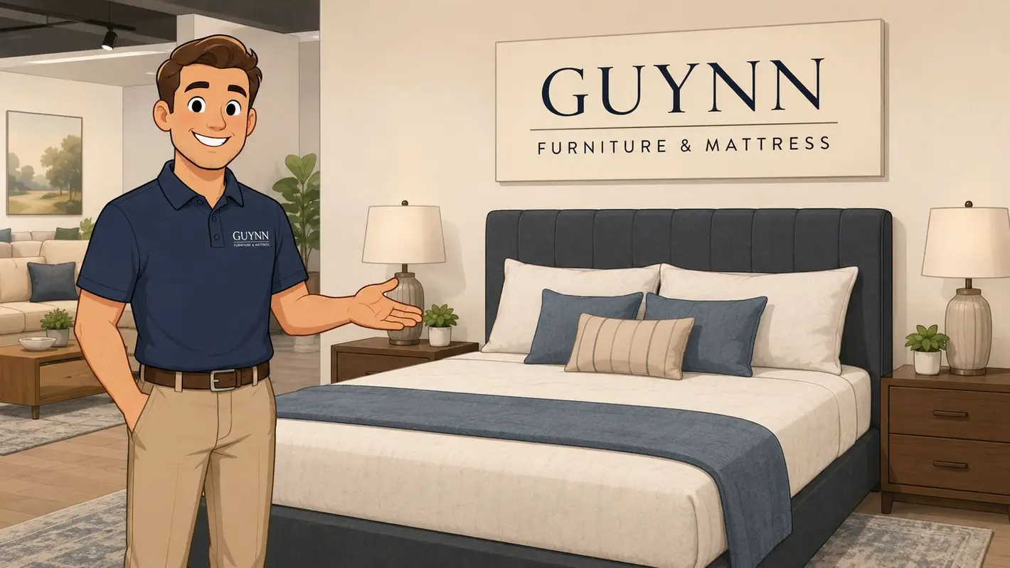 A friendly furniture store employee gesturing towards a stylish bed in a well-decorated showroom.